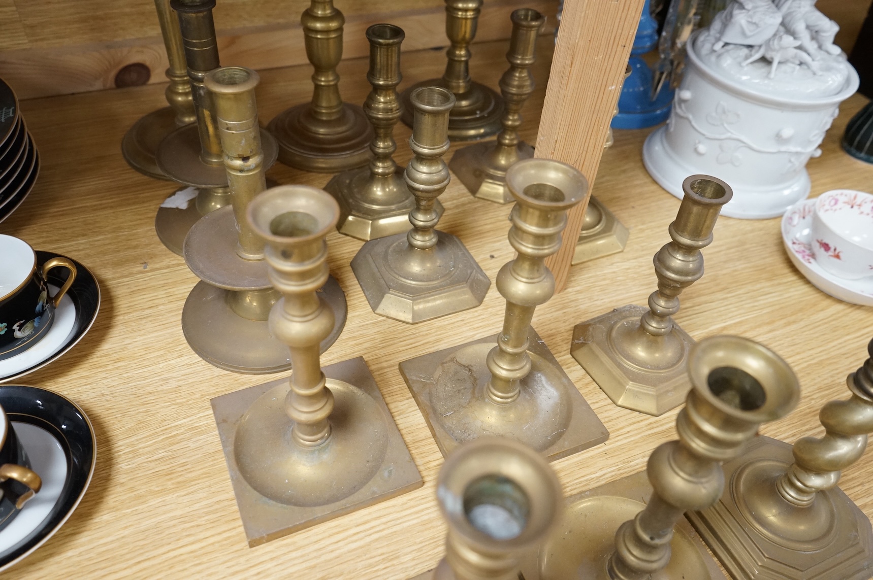 A collection of 19th century and later brass candlesticks, largest 33cm high